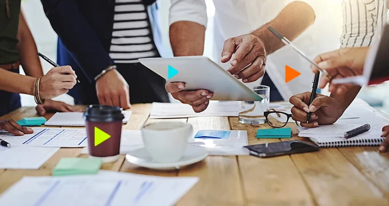 Gestão estratégica: pessoas usando tablet acima de mesa de café