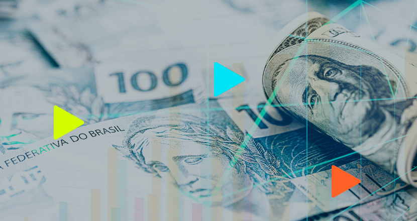 Notas de dinheiro brasileiro e dólar americano juntos.