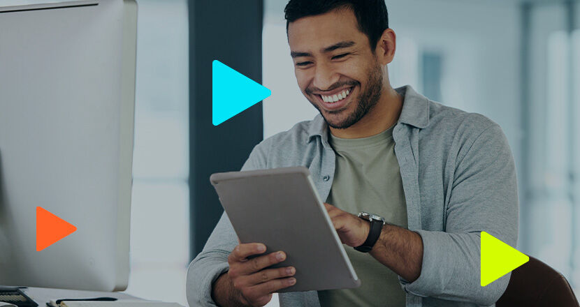 Homem sorridente usando tablet em ambiente de trabalho