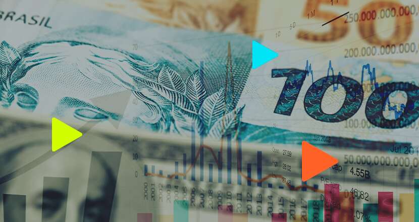 Dinheiro brasileiro em notas de 100 com gráficos financeiros